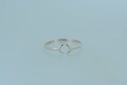 This dainty hand made sterling silver band ring, features two crescent moons that come together at the front. The open design allows for flexibility in fitting.