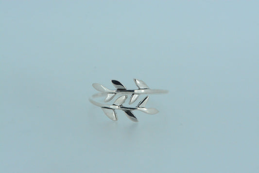 Inspired by nature, this hand made sterling silver ring features two branches of leaves that wrap around the finger. Symbolic of growth, renewal & connection to nature. The open design means flexibility in fitting.