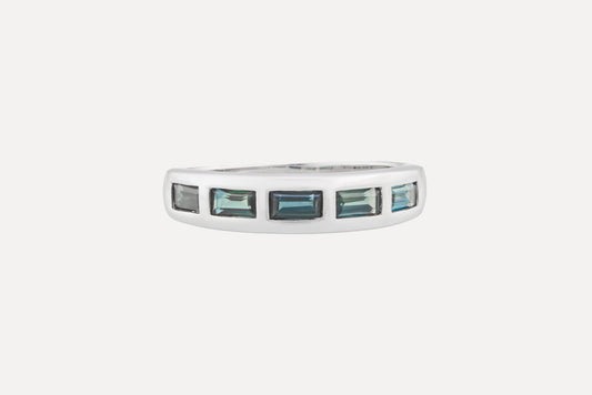 Half circle blue sapphire eternity ring set in sterling silver with rhodium plating.