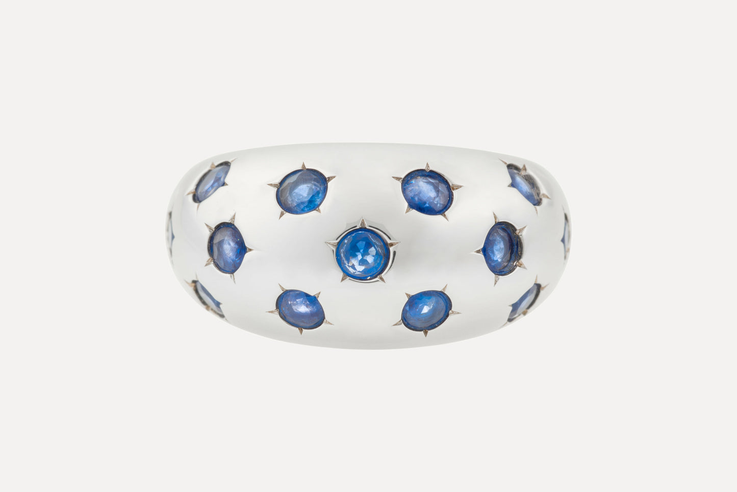 Classic blue sapphires set onto an eye catching dome shaped ring, with rhodium plated sterling silver for a dazzling finish.