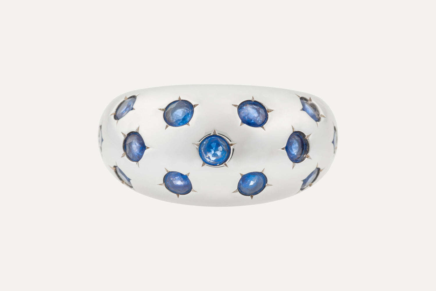 Classic blue sapphires set onto an eye catching dome shaped ring, with rhodium plated sterling silver for a dazzling finish.