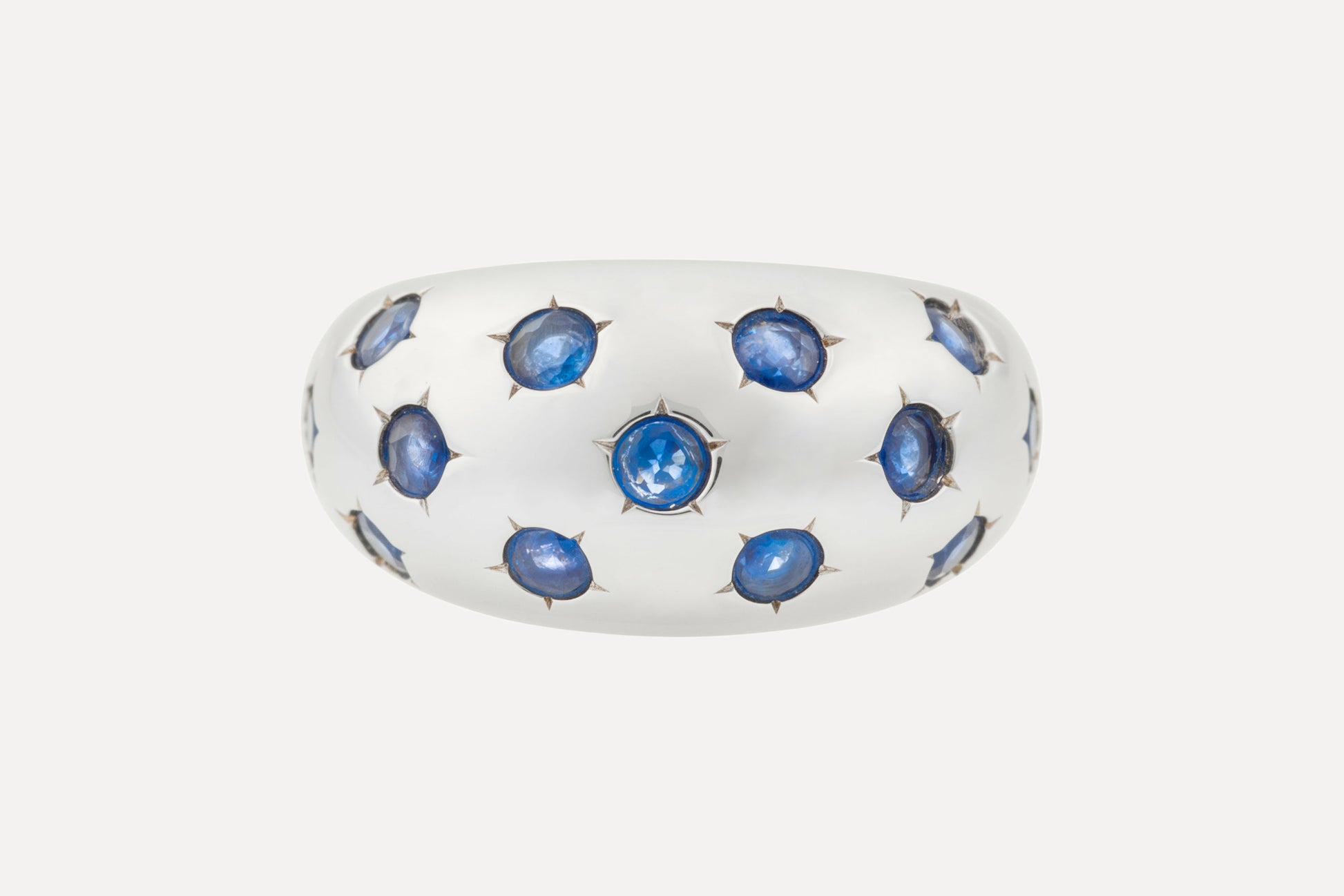 Classic blue sapphires set onto an eye catching dome shaped ring, with rhodium plated sterling silver for a dazzling finish.