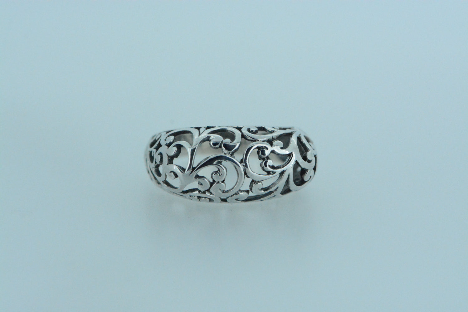 This sterling silver dome ring both textured and bold makes a statement, featuring many swirl motifs reminiscent of organic forms.